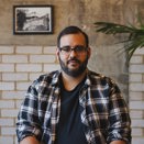 Man with glasses looking at the camera